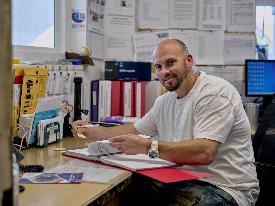 A man sitting at a desk smiling